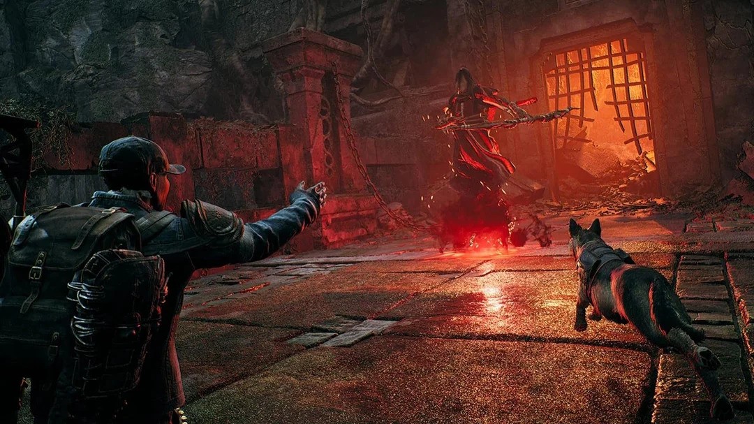 A man plays a game in a dark room, accompanied by a dog sitting beside him